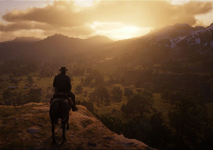 Arthur Morgan overlooking a valley at sunrise in Red Dead Redemption 2